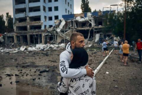 A couple reacts after the Russian shelling in Mykolaiv, Ukraine, Wednesday, Aug. 3, 2022. Accor ...
