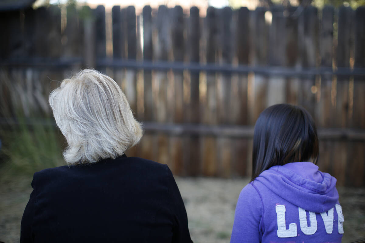MJ and her adoptive mother sit for an interview with The Associated Press in Sierra Vista, Ariz ...