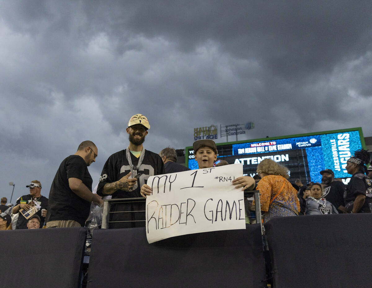 A young Raiders fan stays out during a severe weather alert that the delayed the start of the N ...