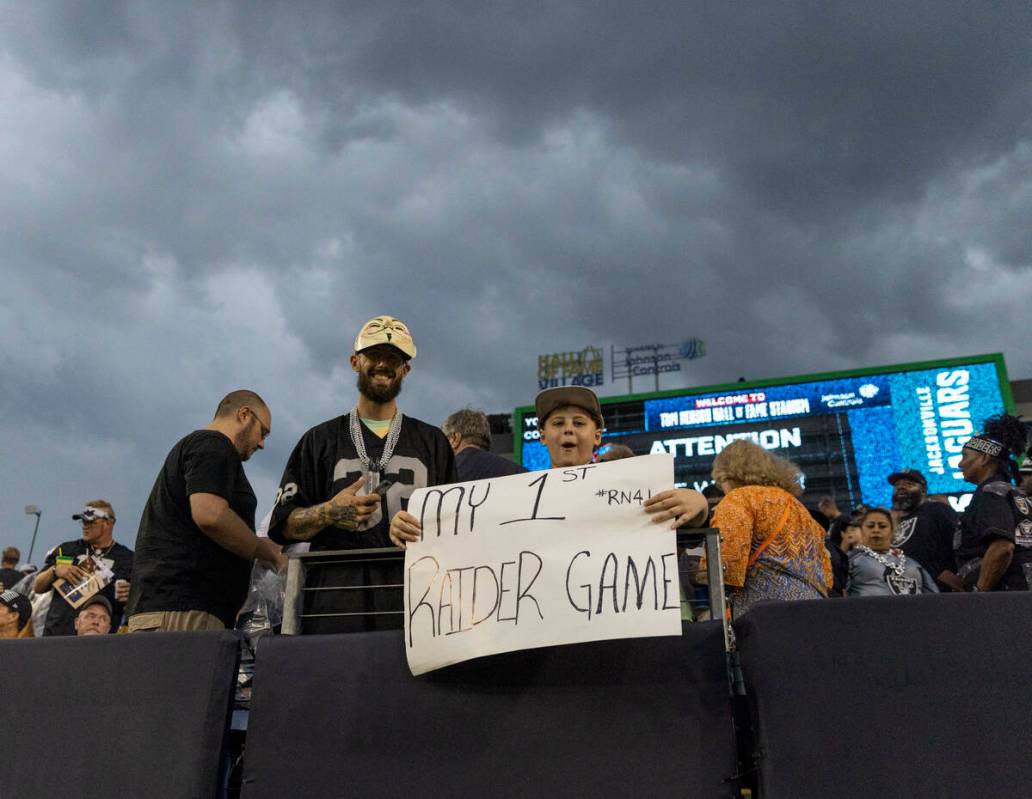 A young Raiders fan stays out during a severe weather alert that the delayed the start of the N ...