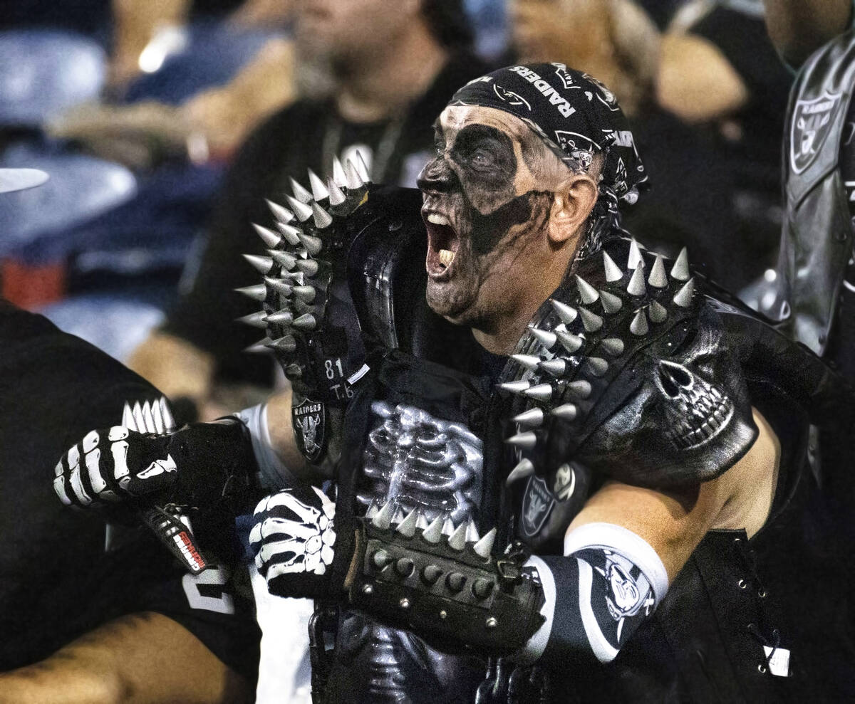 Raiders fan Ricky Van Norde cheers during the first half of the NFL Hall of Fame game at Tom Be ...