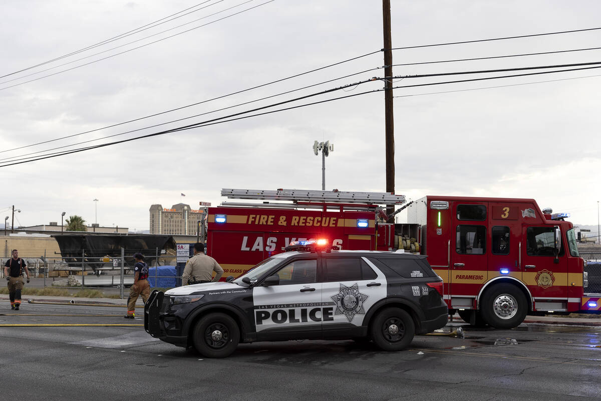 Metropolitan police respond while Las Vegas fire crews put out a fire at 2330 Industrial Road o ...