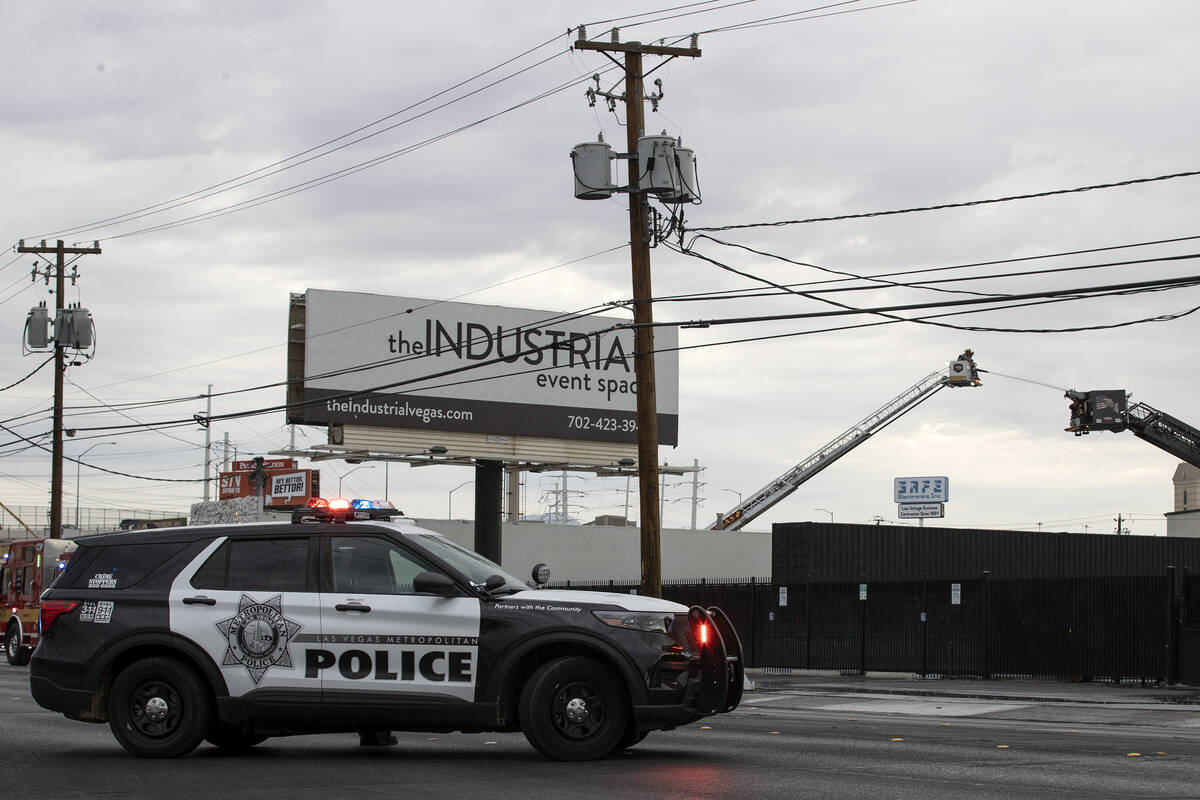 Metropolitan police respond while Las Vegas fire crews put out a fire at 2300 block of Industri ...