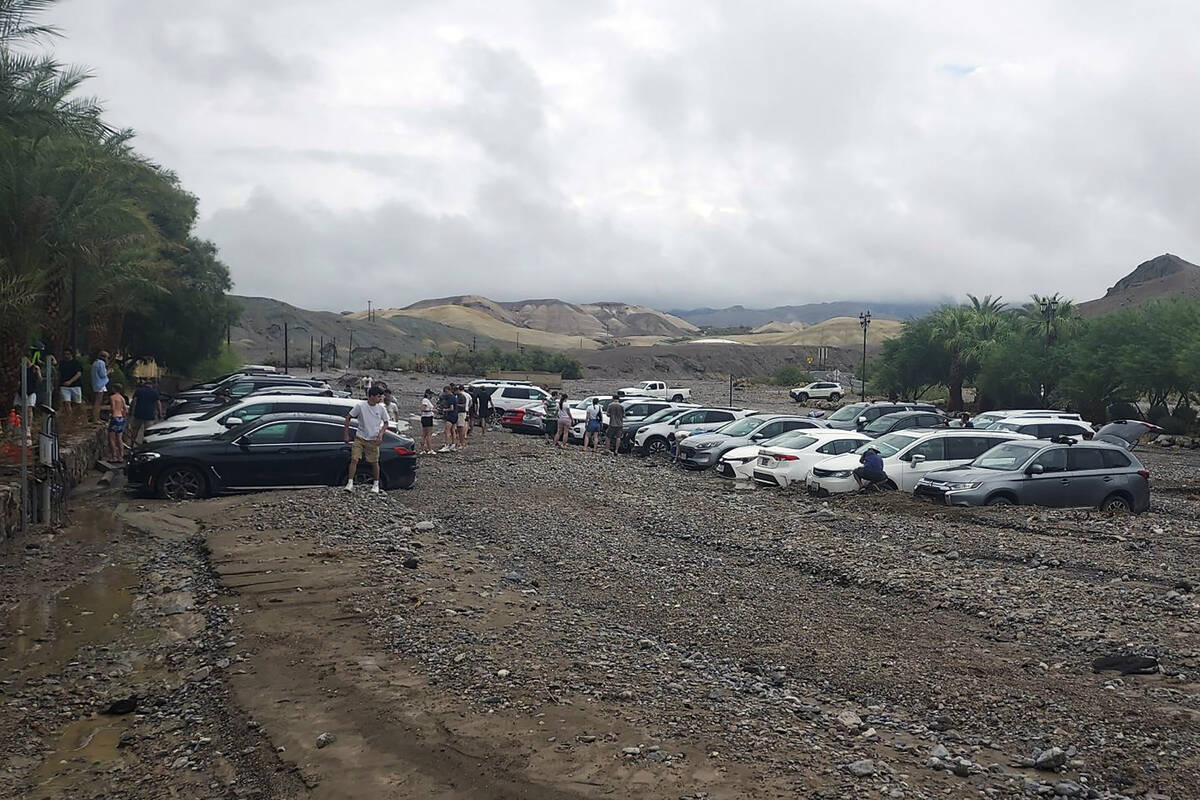 In this photo provided by the National Park Service, cars are stuck in mud and debris from flas ...