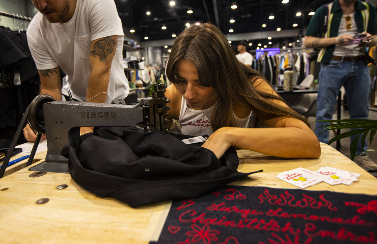 Brooke Jaramillo, owner of Large Lemonade, works on custom chainstitch embroidering during the ...