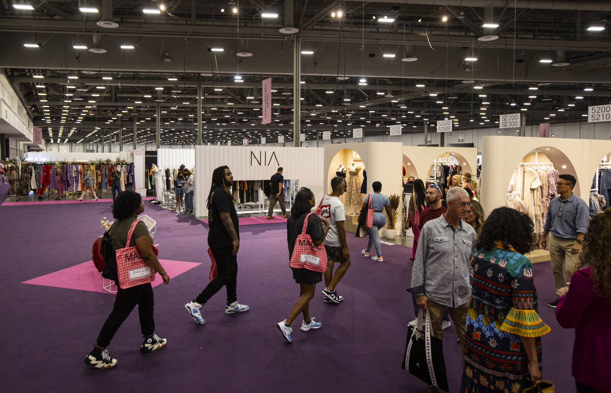 People walk the show floor during the MAGIC Las Vegas fashion trade show on Monday, Aug. 8, 202 ...
