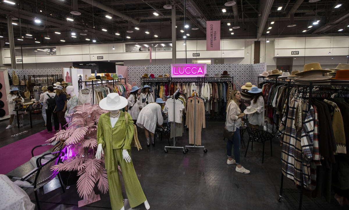 People explore the Lucca booth during the MAGIC Las Vegas fashion trade show on Monday, Aug. 8, ...