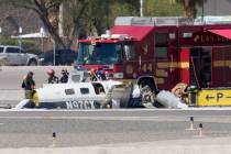 FILE - Officials investigate the wreckage of a plane at the site of a fatal crash at the North ...