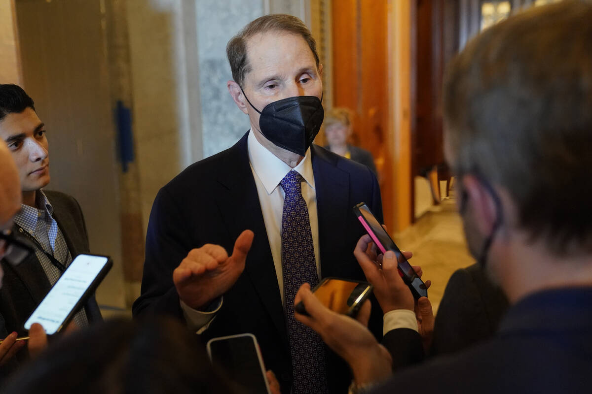Sen. Ron Wyden, D-Ore., speaks with reporters on Capitol Hill in Washington, Saturday, Aug. 6, ...