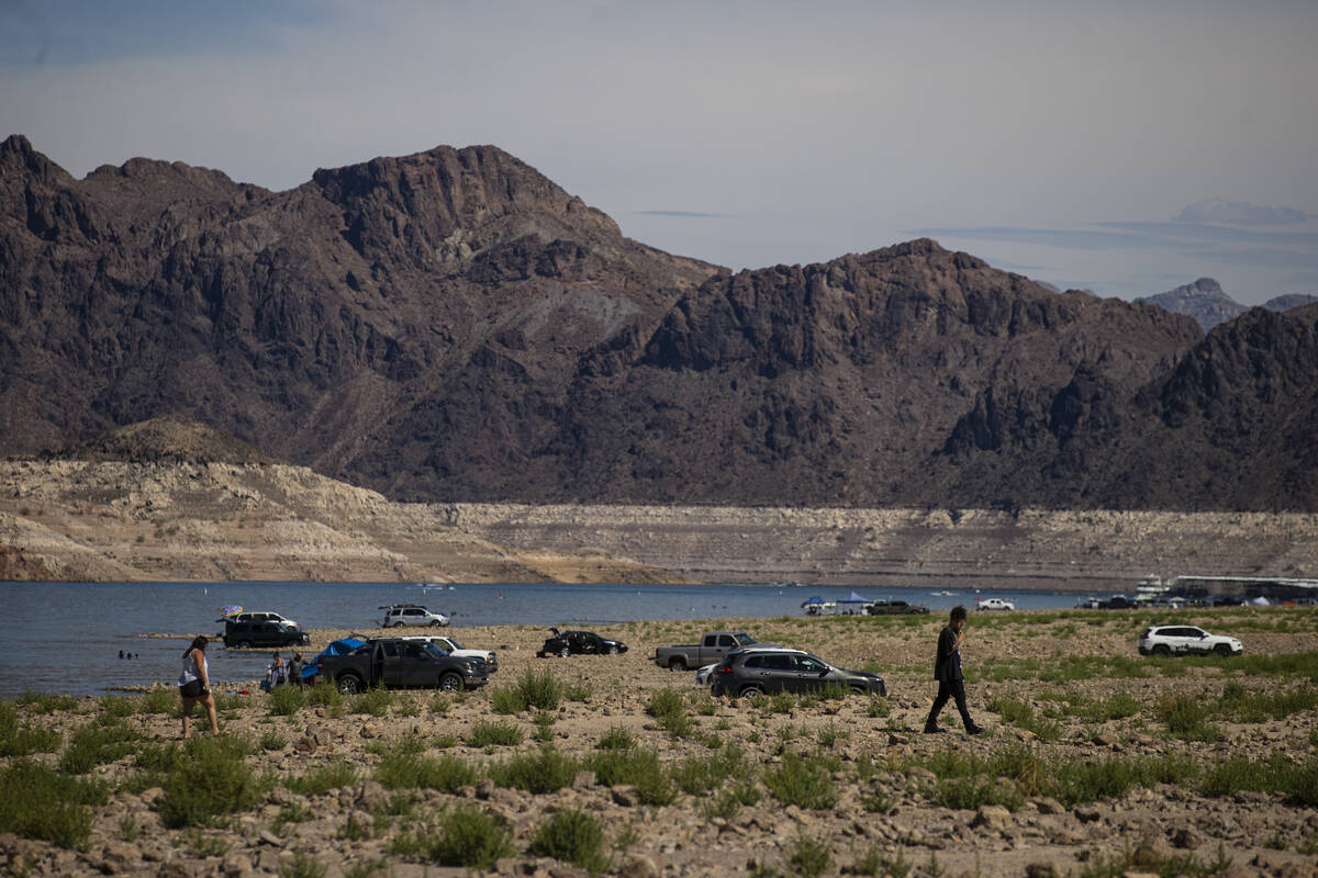 People walk by Swim Beach, along the Boulder Basin and Boulder Beach area, at Lake Mead Nationa ...