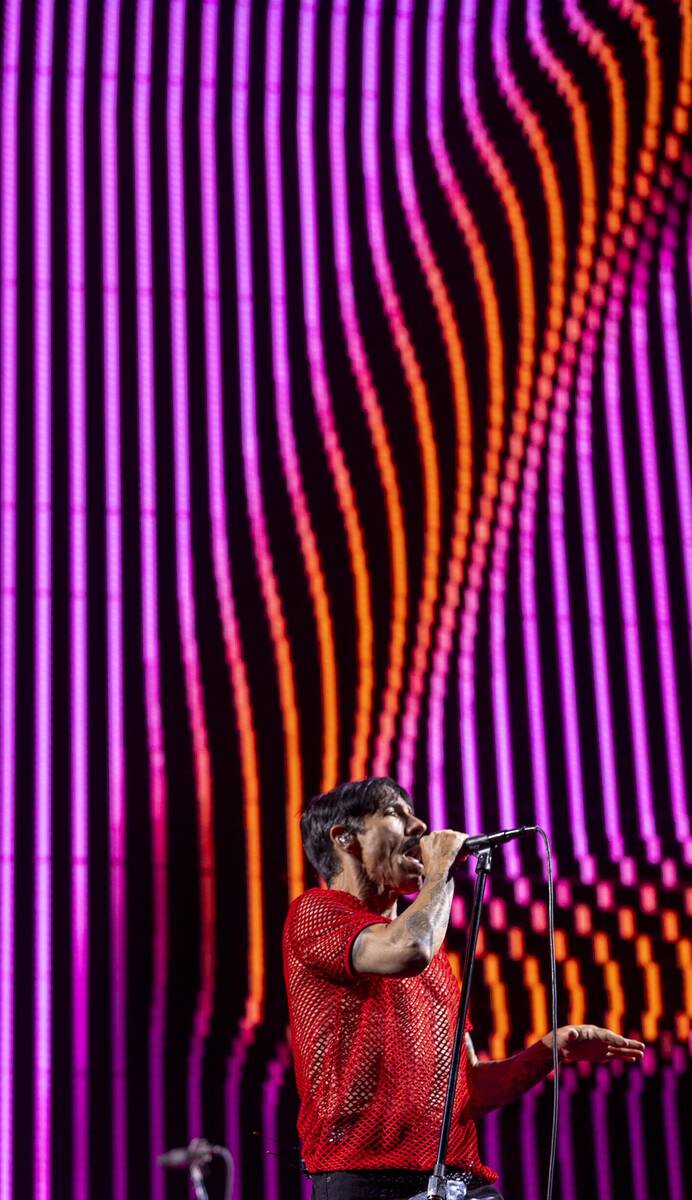 (From left) Lead singer Anthony Kiedis sings with The Red Hot Chili Peppers at Allegiant Stadiu ...