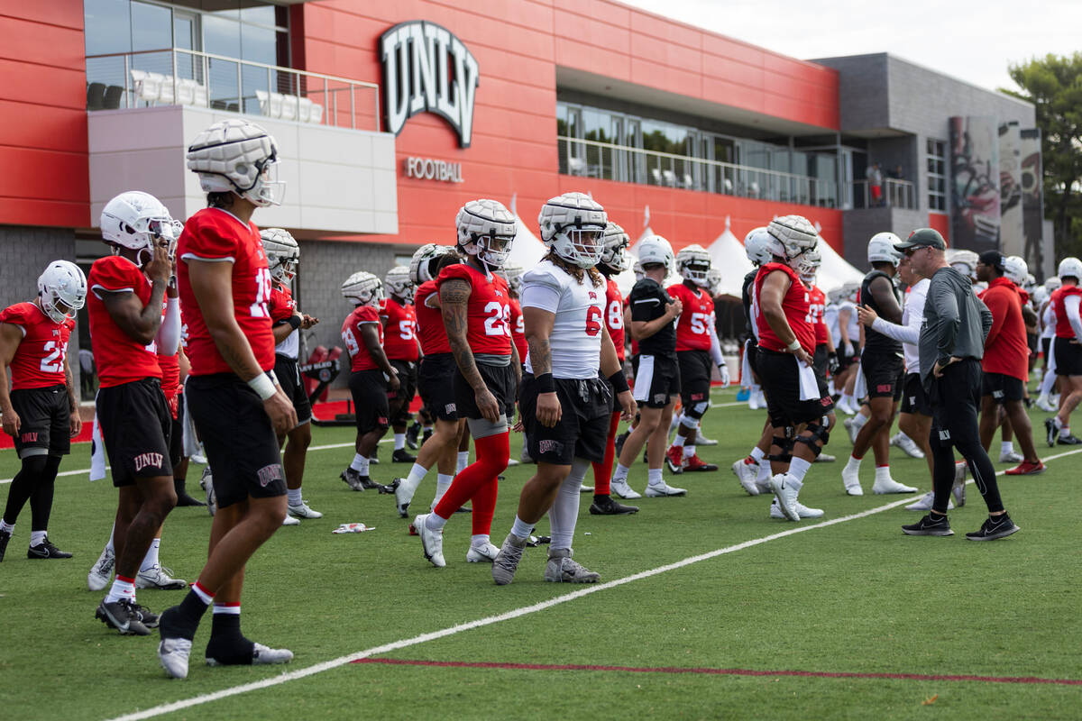UNLV players warm up during a team football practice at UNLV in Las Vegas, Saturday, July 30, 2 ...