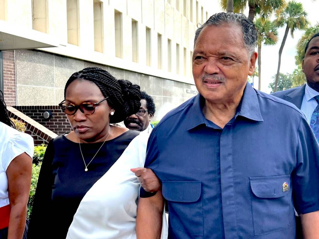 Rev. Jesse Jackson escorts Wanda Cooper Jones, Ahmaud Arbery's mother, into the federal courtho ...