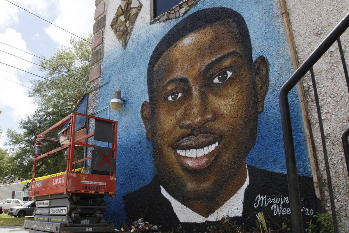 FILE - A recently painted mural of Ahmaud Arbery is displayed in Brunswick, Ga., on May 17, 202 ...