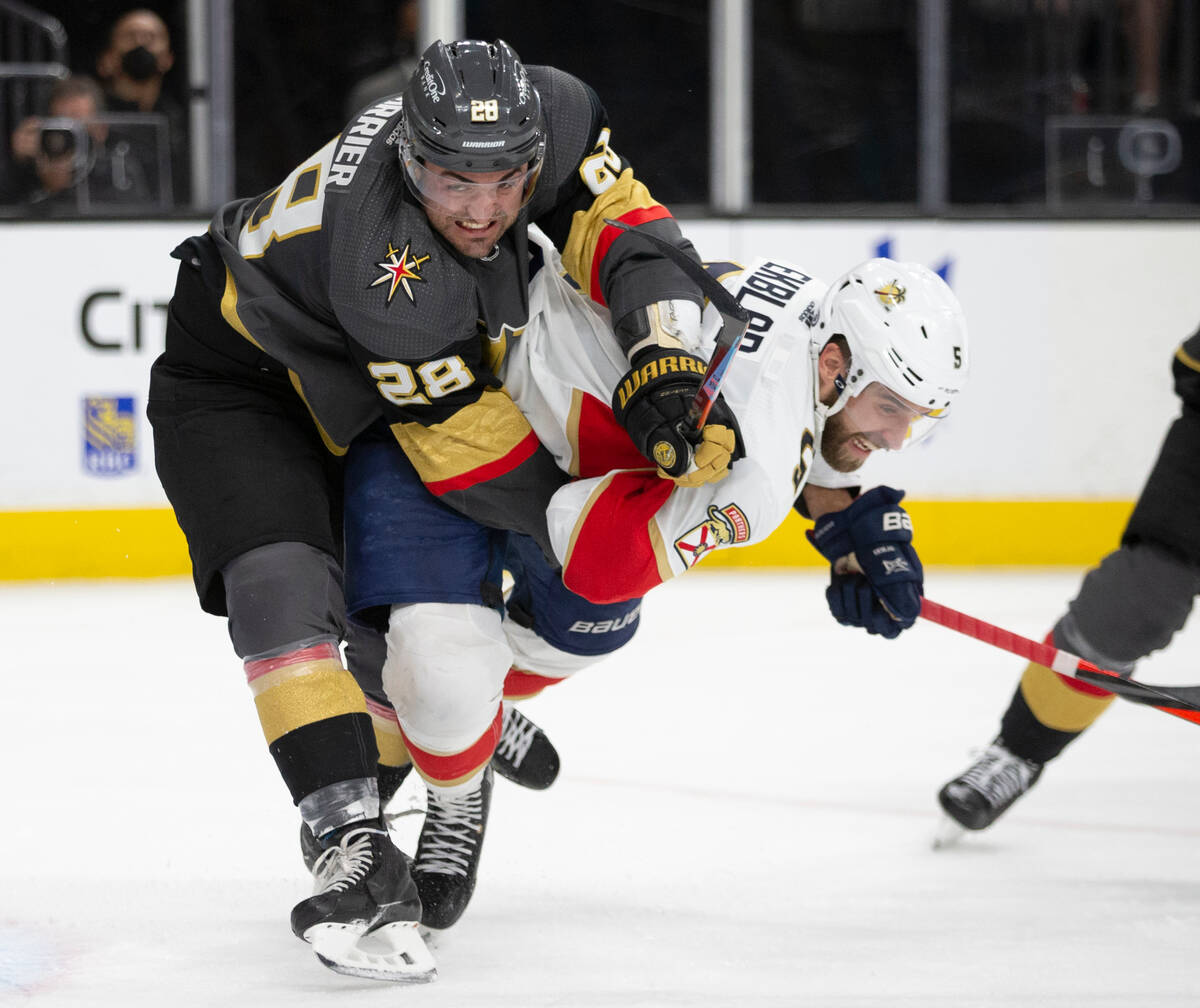 Golden Knights left wing William Carrier (28) collides with Panthers defenseman Aaron Ekblad (5 ...