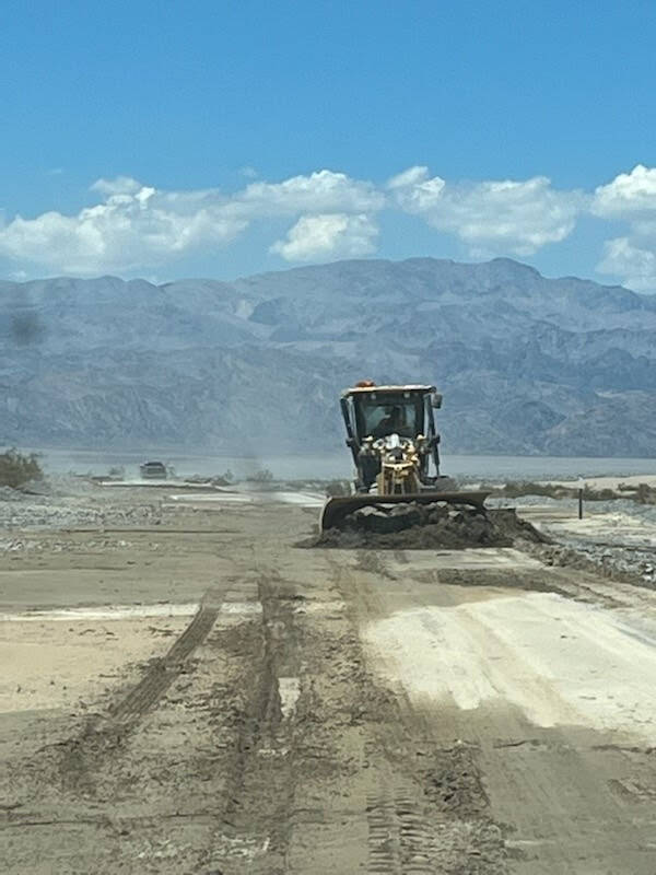 A section of State Route 190 near Stovepipe Wells is covered in mud August 6. (California Depar ...