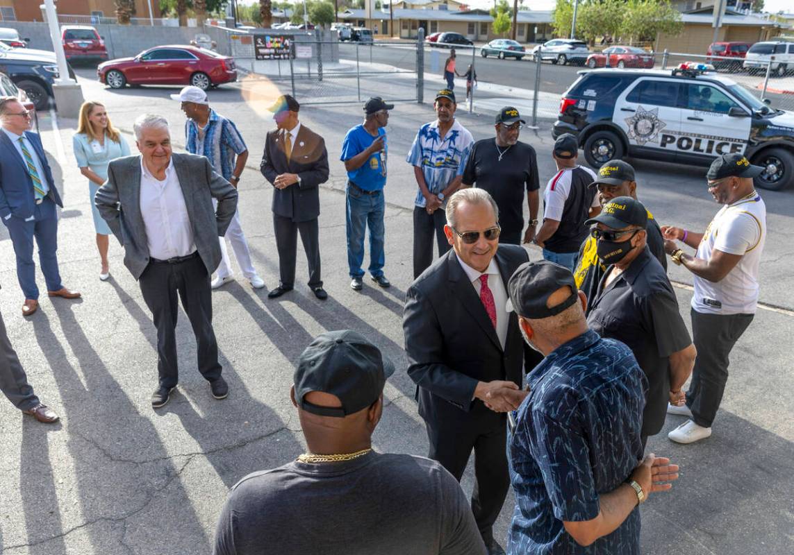 CCSD Superintendent Jesus Jara and Gov. Steve Sisolak greet members of the Original Gentlemen a ...