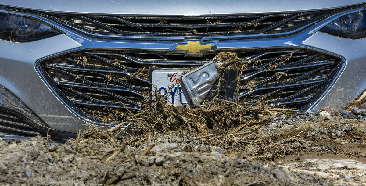 Cars remain stuck in mud flows in the parking lot of The Inn at Death Valley at the national pa ...