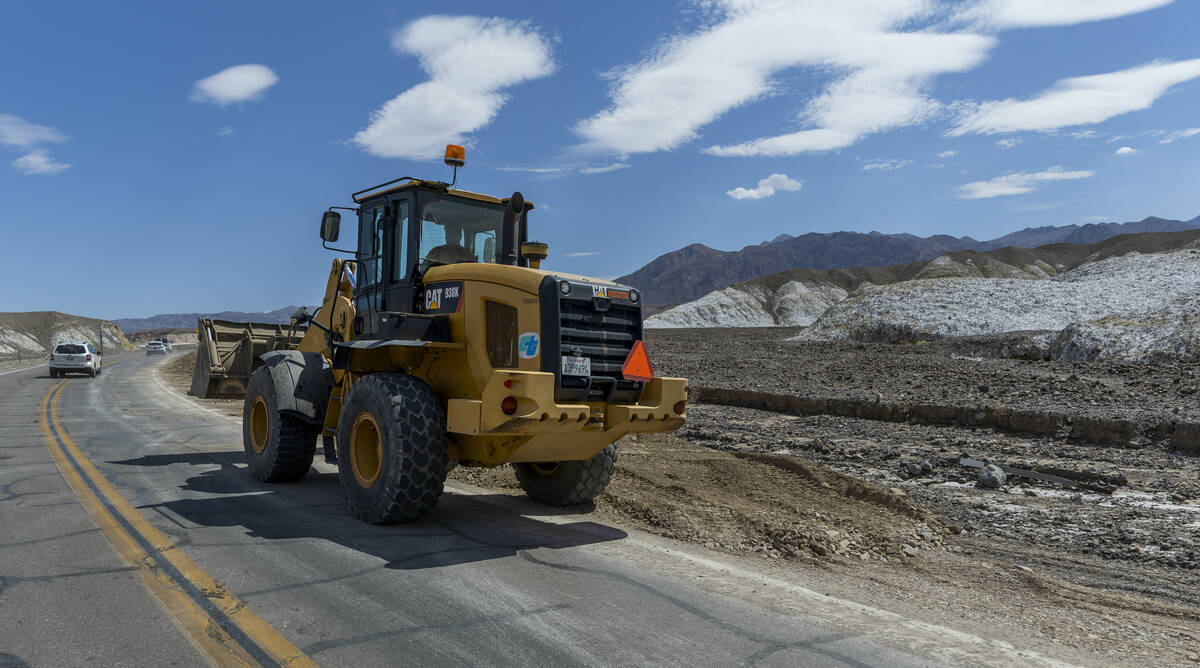 Construction machinery continues to clear State Route 190 of mud flows within Death Valley Nati ...