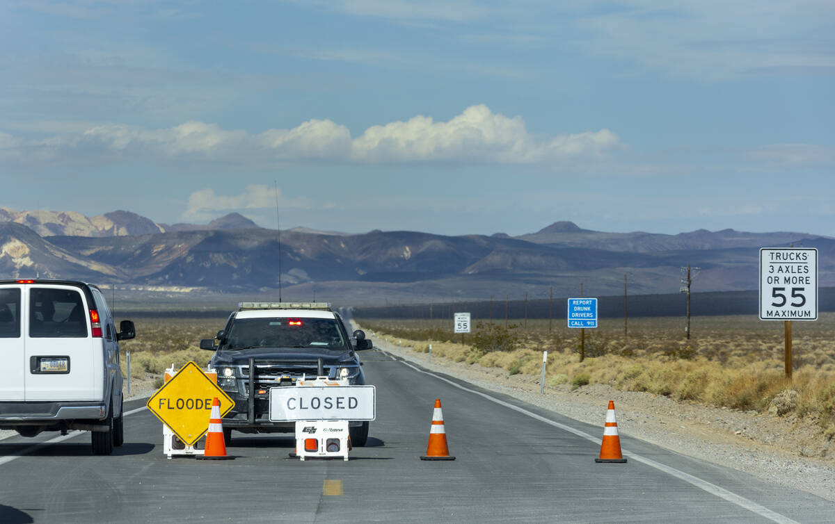 A roadblock remains on State Route 190 leading into Death Valley National Park following monsoo ...