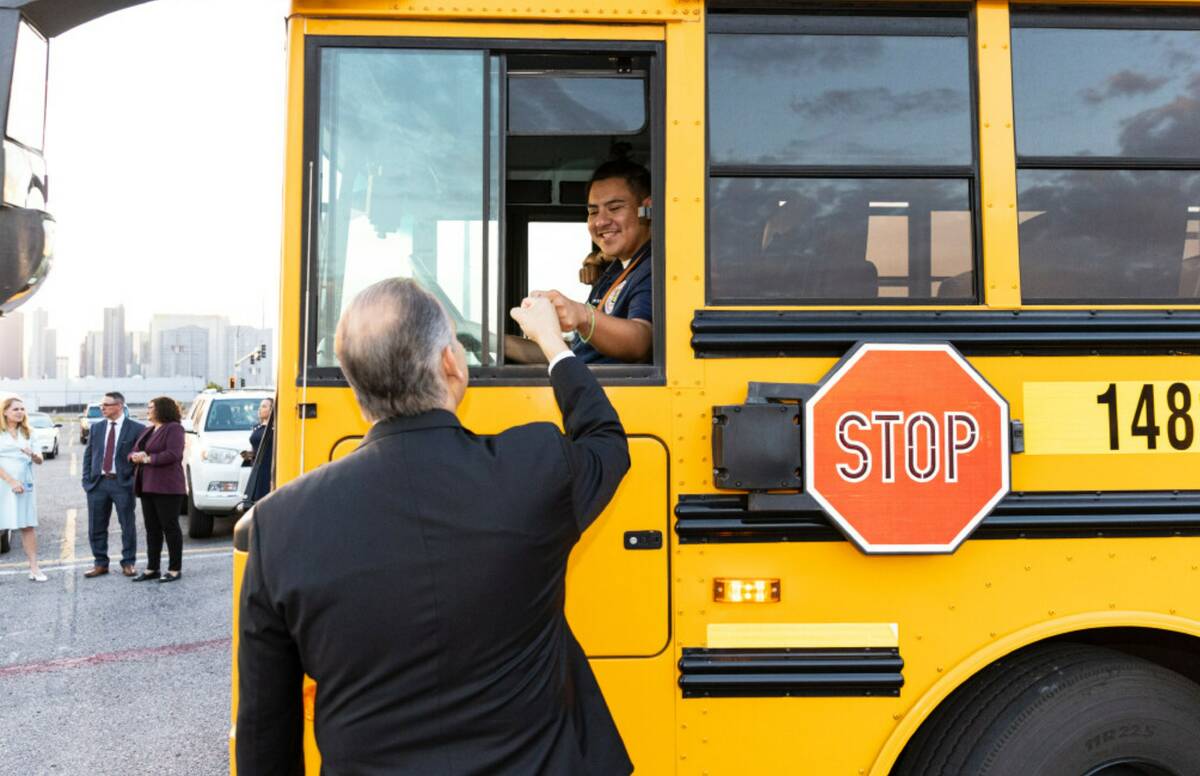 Clark County School District Superintendent Jesus Jara fist bumps with a school bus driver at t ...
