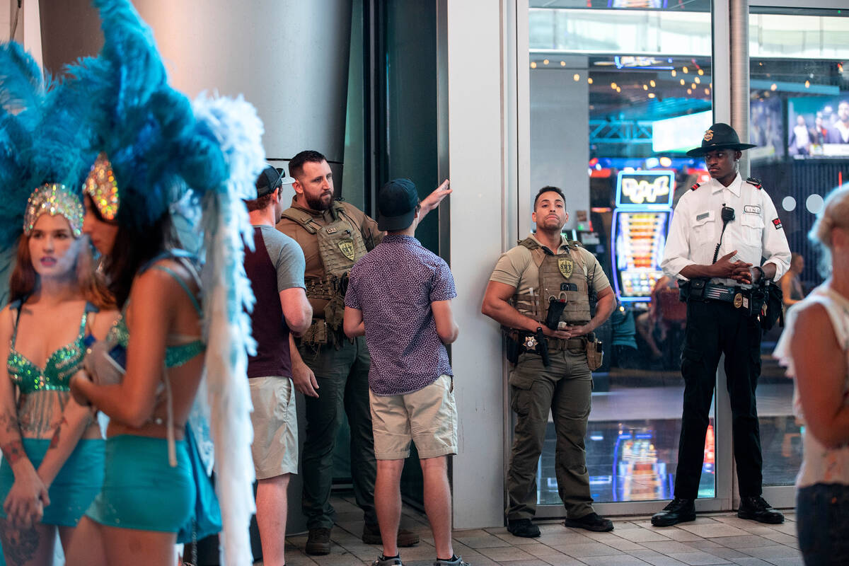 Security guards monitor the scene at the LINQ Promenade on the Las Vegas Strip, Tuesday, Aug. 2 ...