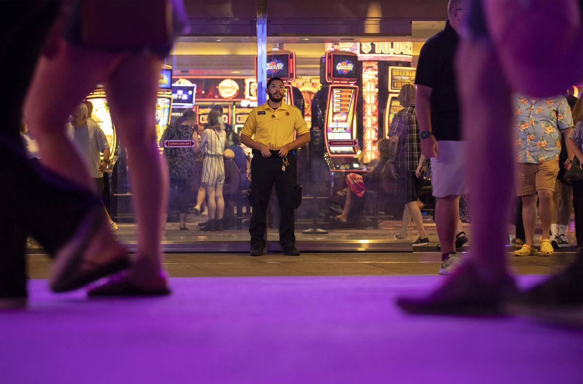A security guard is posted outside Harrah’s on the Las Vegas Strip, Tuesday, Aug. 2, 202 ...