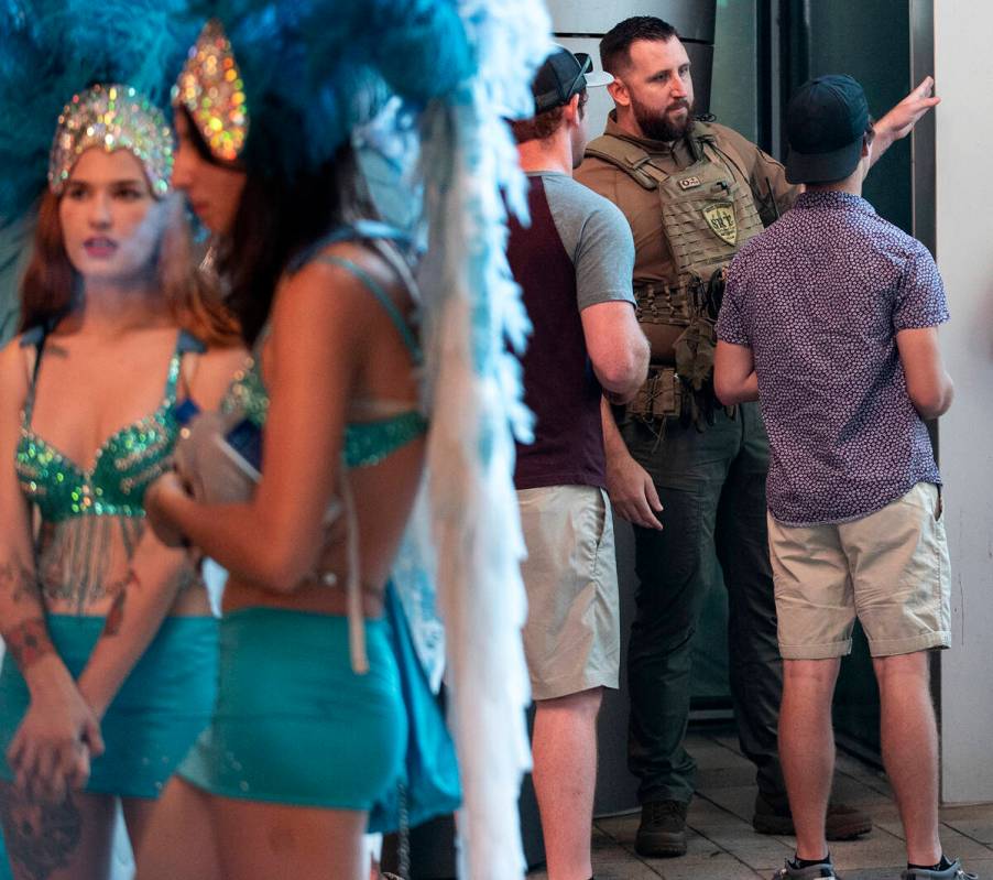 Security guards monitor the scene at the LINQ Promenade on the Las Vegas Strip, Tuesday, Aug. 2 ...