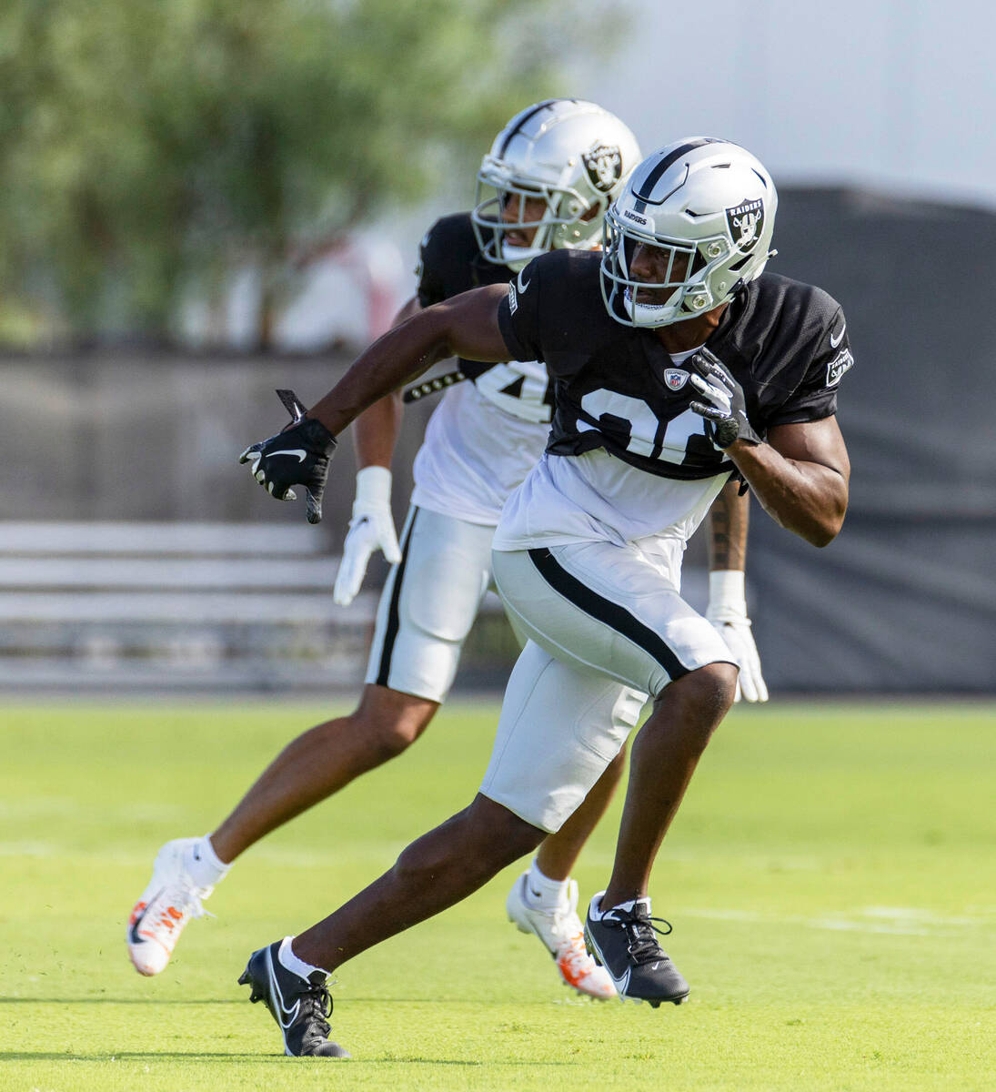 Raiders safety Isaiah Pola-Mao (40) runs with Raiders safety Duron Harmon (30) during the team& ...