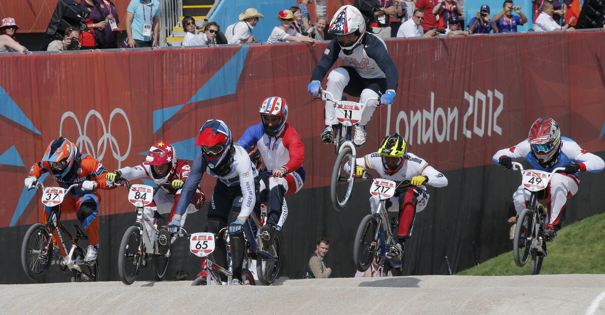 United States' Connor Fields (11) leads the competition in a BMX cycling men's quarterfinal ru ...