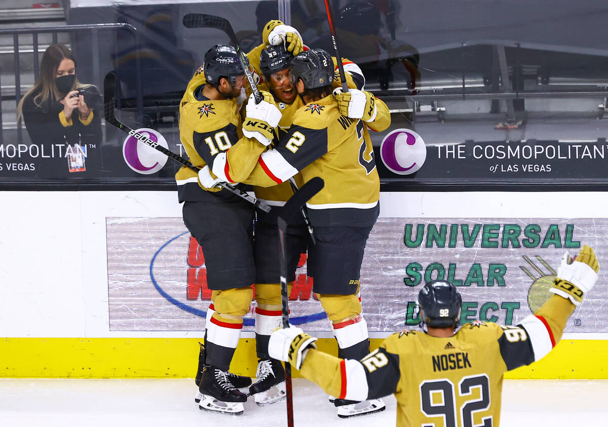 Golden Knights' Keegan Kolesar, second from left, celebrates with Nicolas Roy (10) and Zach Whi ...