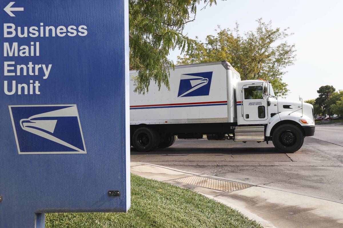 A truck departs from the U.S. Postal Service center at 1001 E. Sunset Road in Las Vegas on Thur ...