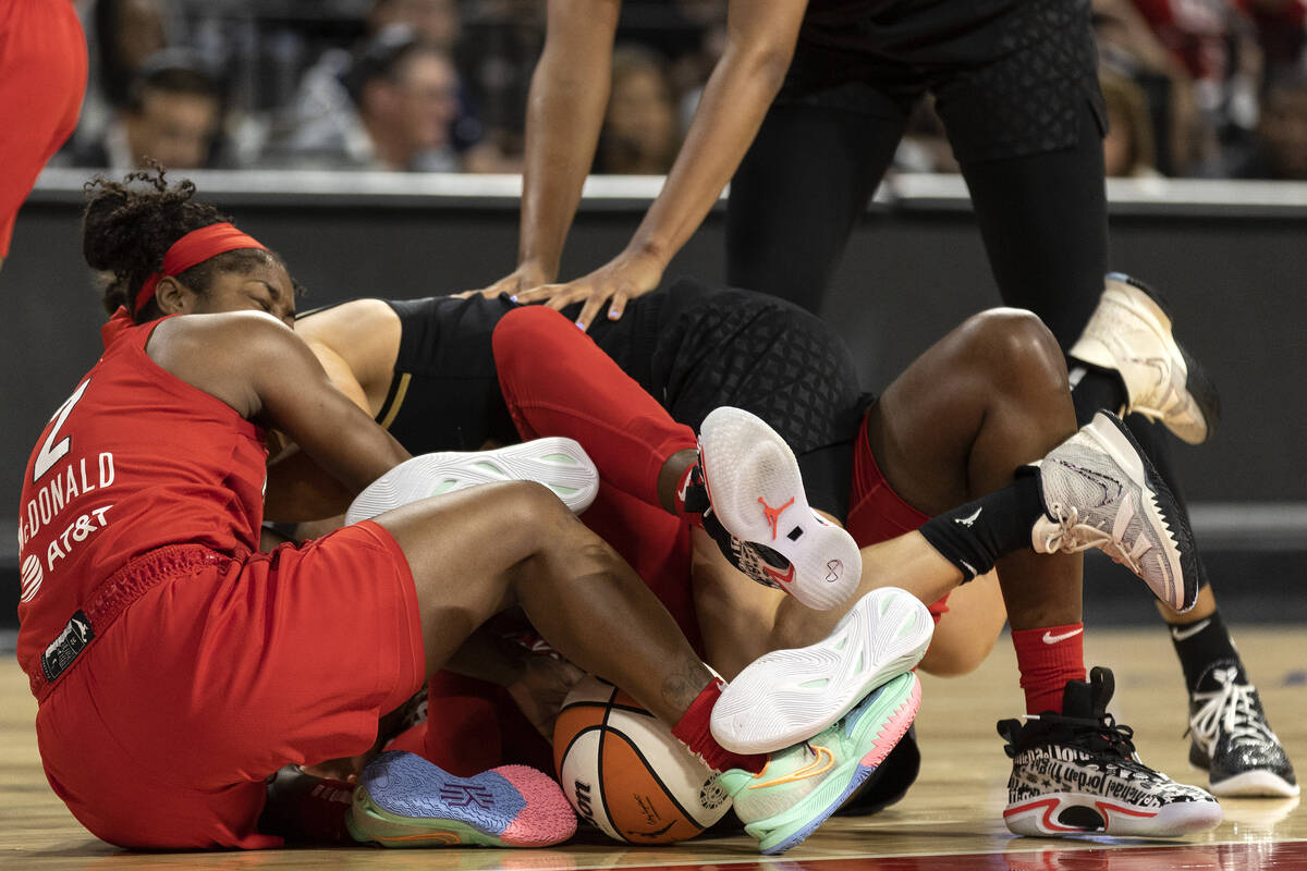 Players including Atlanta Dream guard Aari McDonald (2) and Las Vegas Aces guard Kelsey Plum, t ...