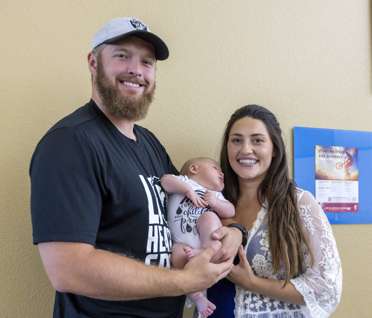 Raiders long snapper Trent Sieg, left, his wife Carly Sieg, right, and their three-month-old so ...