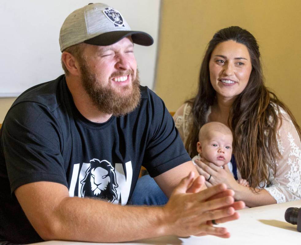 Raiders long snapper Trent Sieg, left, his wife Carly Sieg, right, and their three-month-old so ...