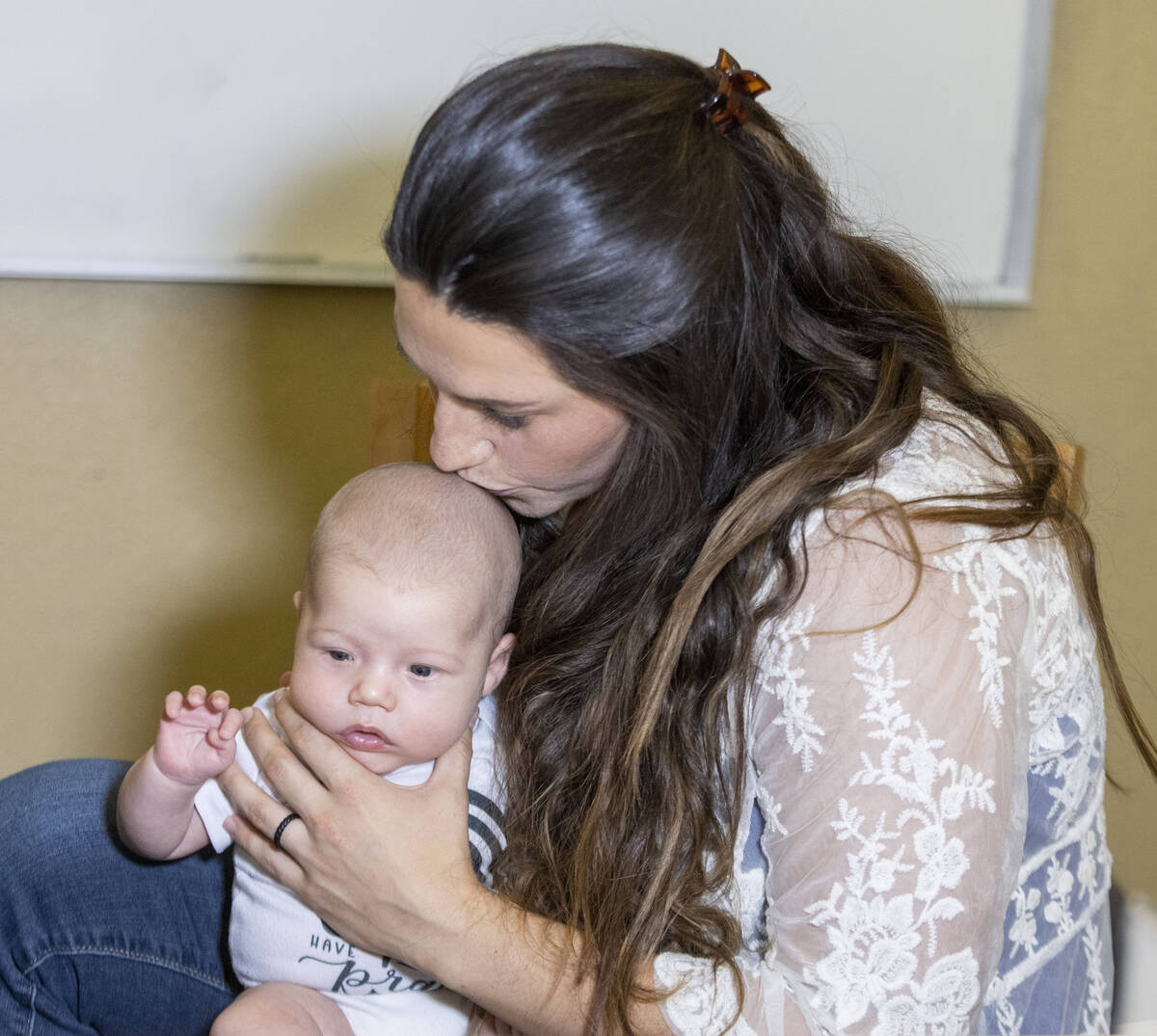 Carly Sieg, wife of Raiders long snapper Trent Sieg, not pictured, kisses their three-month-old ...