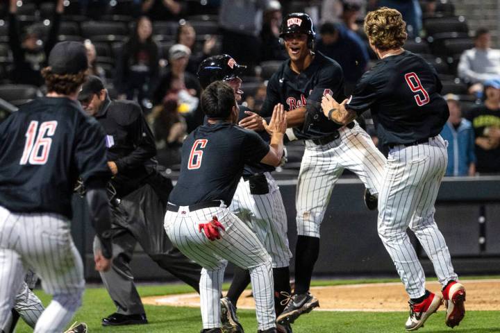 UNLV infielder Edarian Williams (2) celebrates with his teammates after scoring the winning run ...