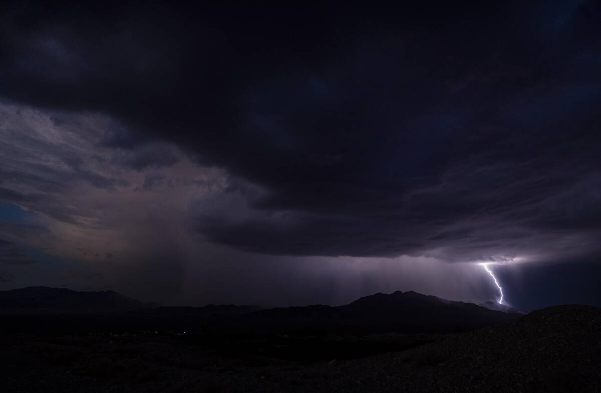 Lightning erupts as a monsoon storm moves across the valley on Thursday, Aug. 11, 2022, in Las ...