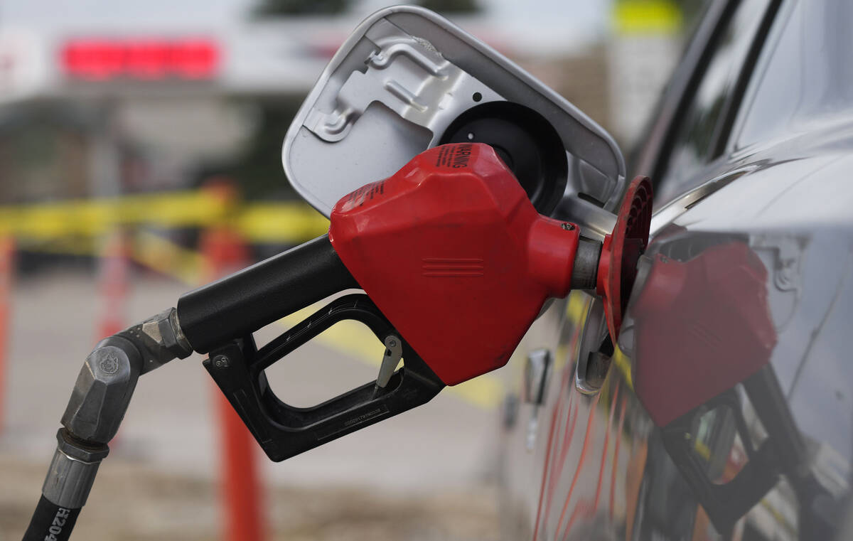 FILE - A motorist fills up the tank on a sedan, on July 22, 2022, in Saratoga, Wyo. Gasoline pr ...