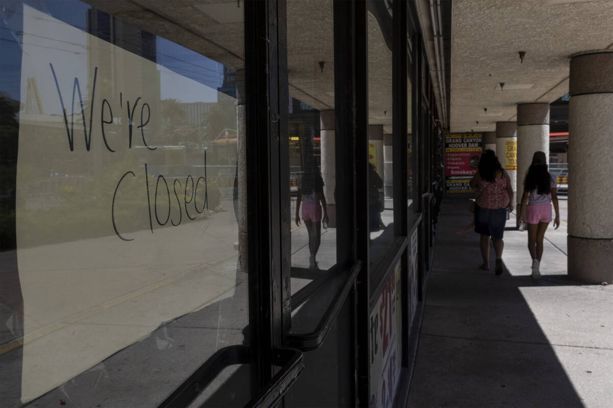 Pedestrians walk past closed stores in the Cable Center Shops, Wednesday, June 29, 2022, on the ...