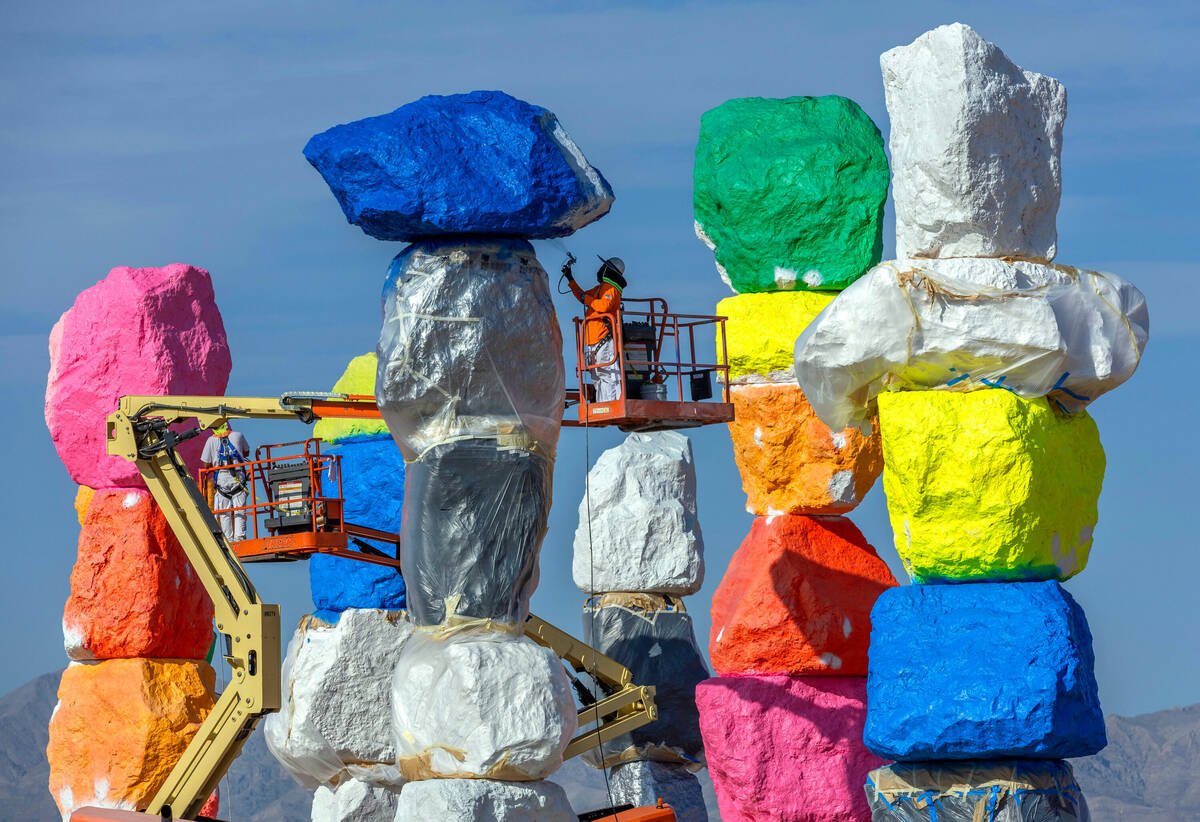 Journeyman Painters Paul Davis, left, and Ivan Barerra, right, apply base coats to stones at S ...