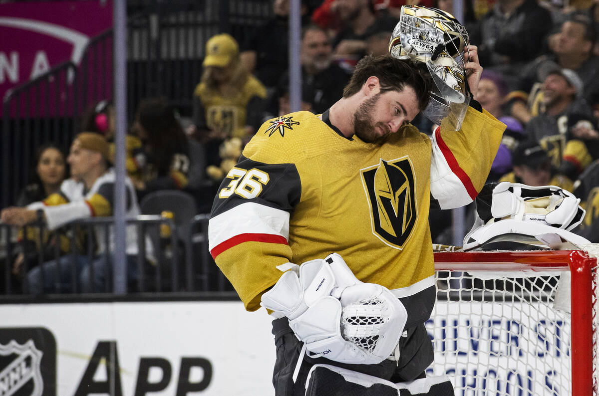 Golden Knights goaltender Logan Thompson (36) puts his helmet back on after giving up a goal in ...