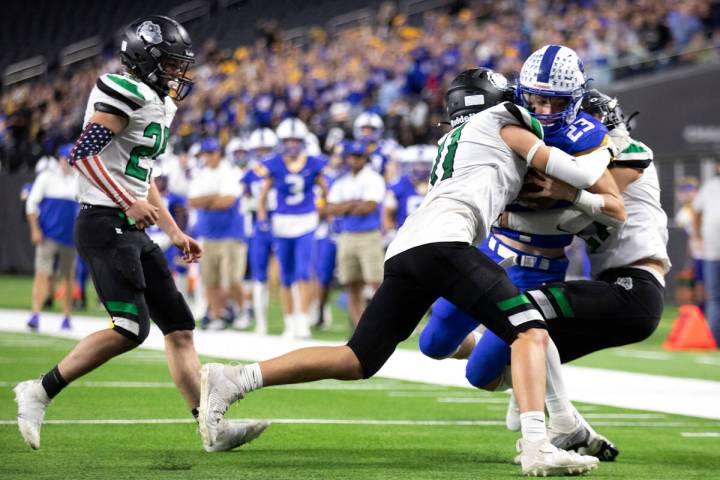 Moapa Valley running back Landon Wrzesinski (23) is tackled just before the endzone by Virgin V ...