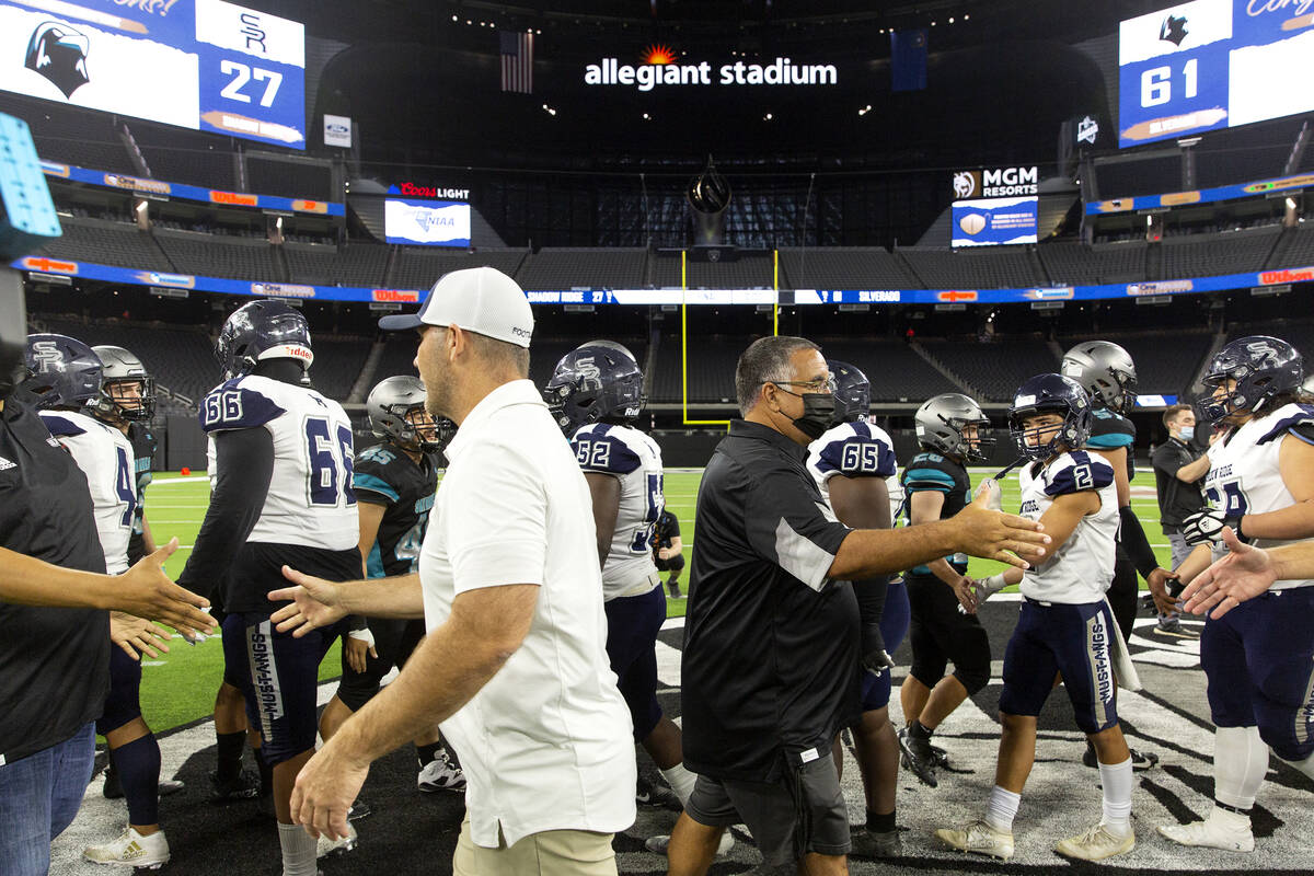 Shadow Ridge head coach Travis Foster and Silverado head coach Alejandro Ostolaza shake hands a ...