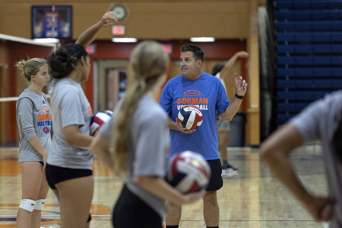 Coach Gregg Nunley instructs his team during a girls high school volleyball practice at Bishop ...