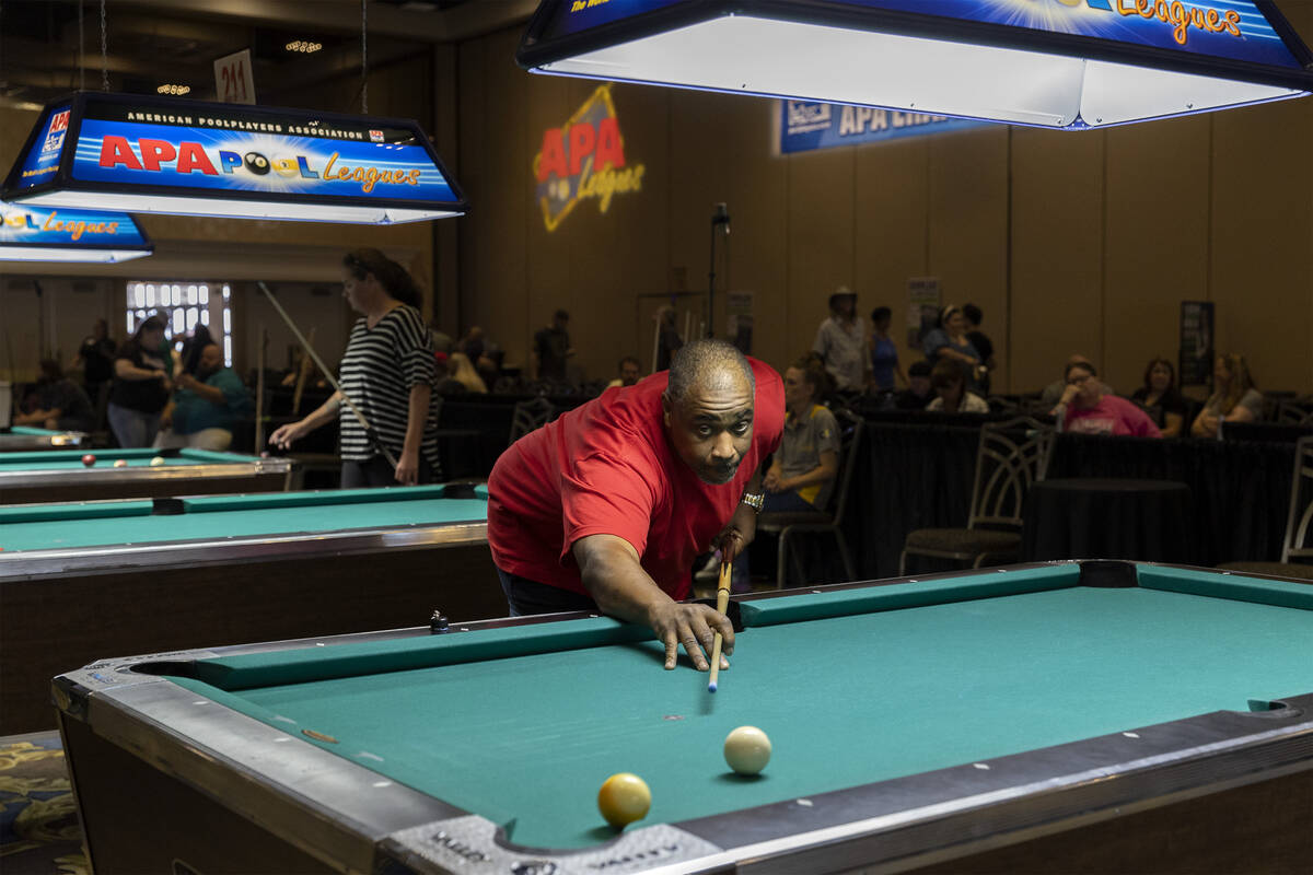 Damon Johnson, of Detroit, shoots the shot that wins his game during the American Poolplayers A ...