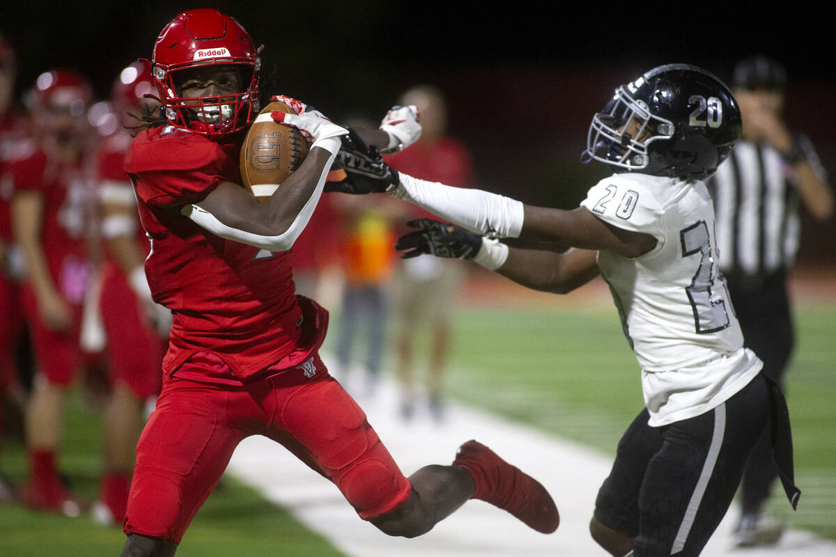 Arbor View's David Washington (18) tumbles into the sidelines after rushing the ball as Desert ...