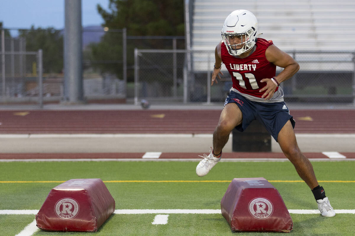 Koi Paaoao runs a drill during a team football practice at Liberty High School in Henderson, Mo ...