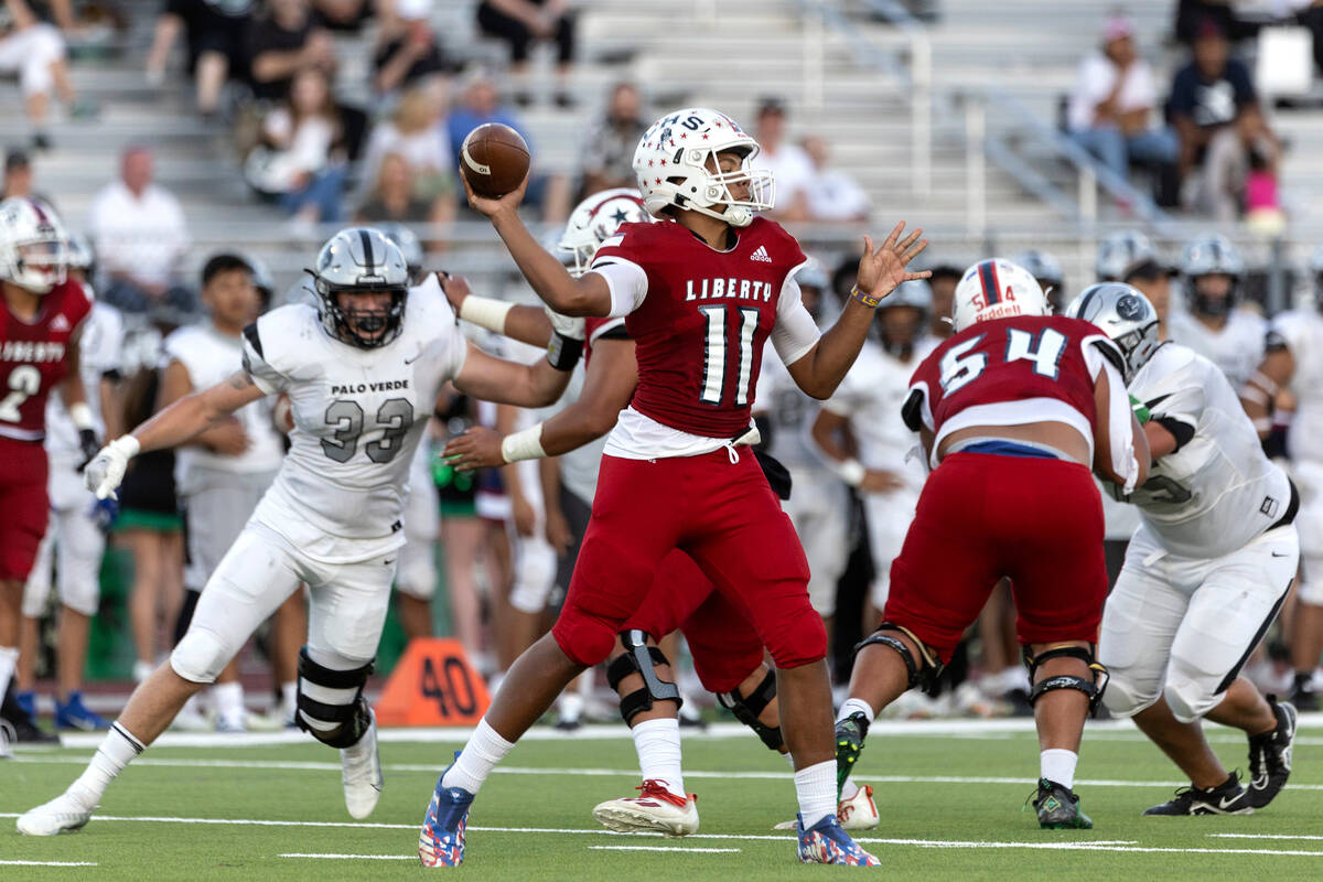 Liberty’s Tyrese Smith (11) passes the ball while Palo Verde’s Sam Builes (33) ci ...