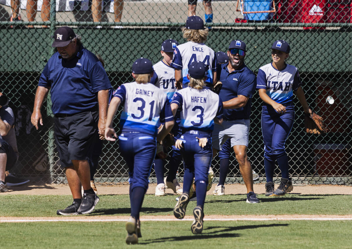 Paseo Veda's head coach Bill Senne, left, walks past Utah-Snow Canyon players as they celebrate ...